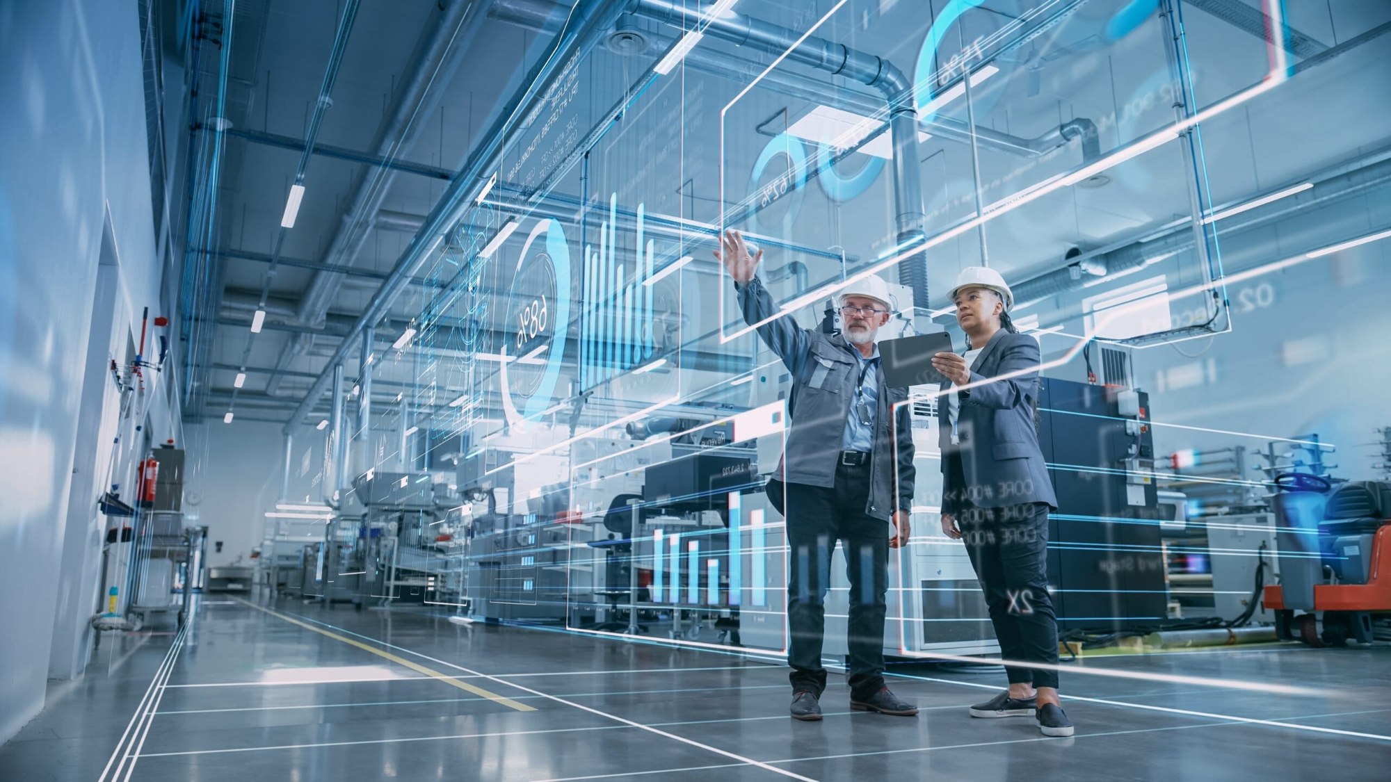 Engineers using augmented reality technology in a manufacturing facility