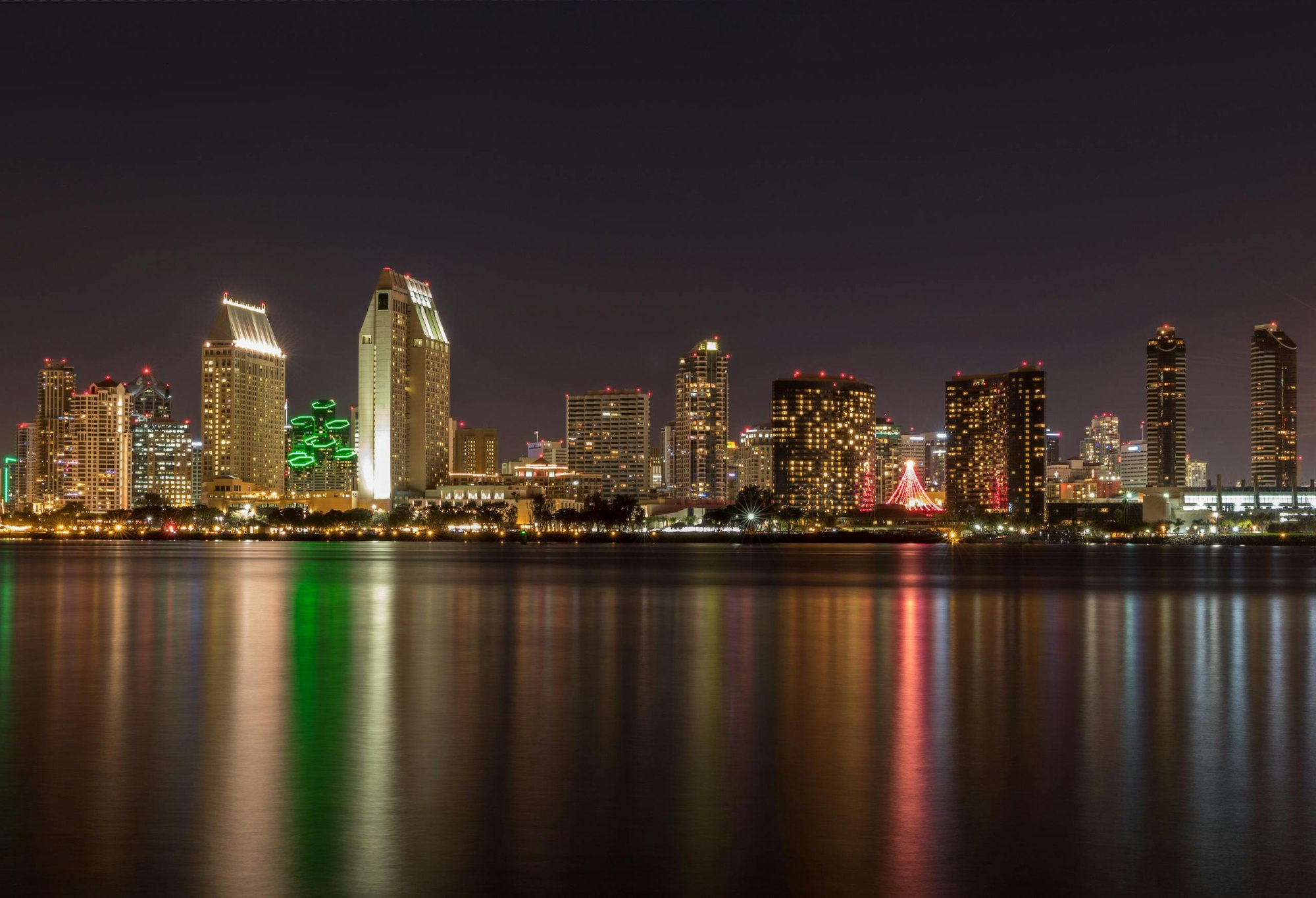 Captivating View Of San Diegos Skyline Illuminated At Night Reflecting In The Calm Waters. 258695 Scaled