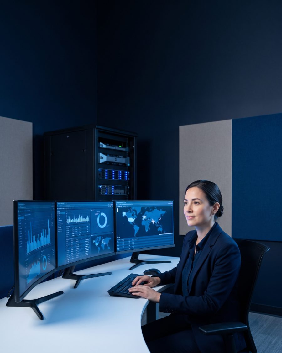 Security analyst reviewing threat monitoring dashboards in an operations center