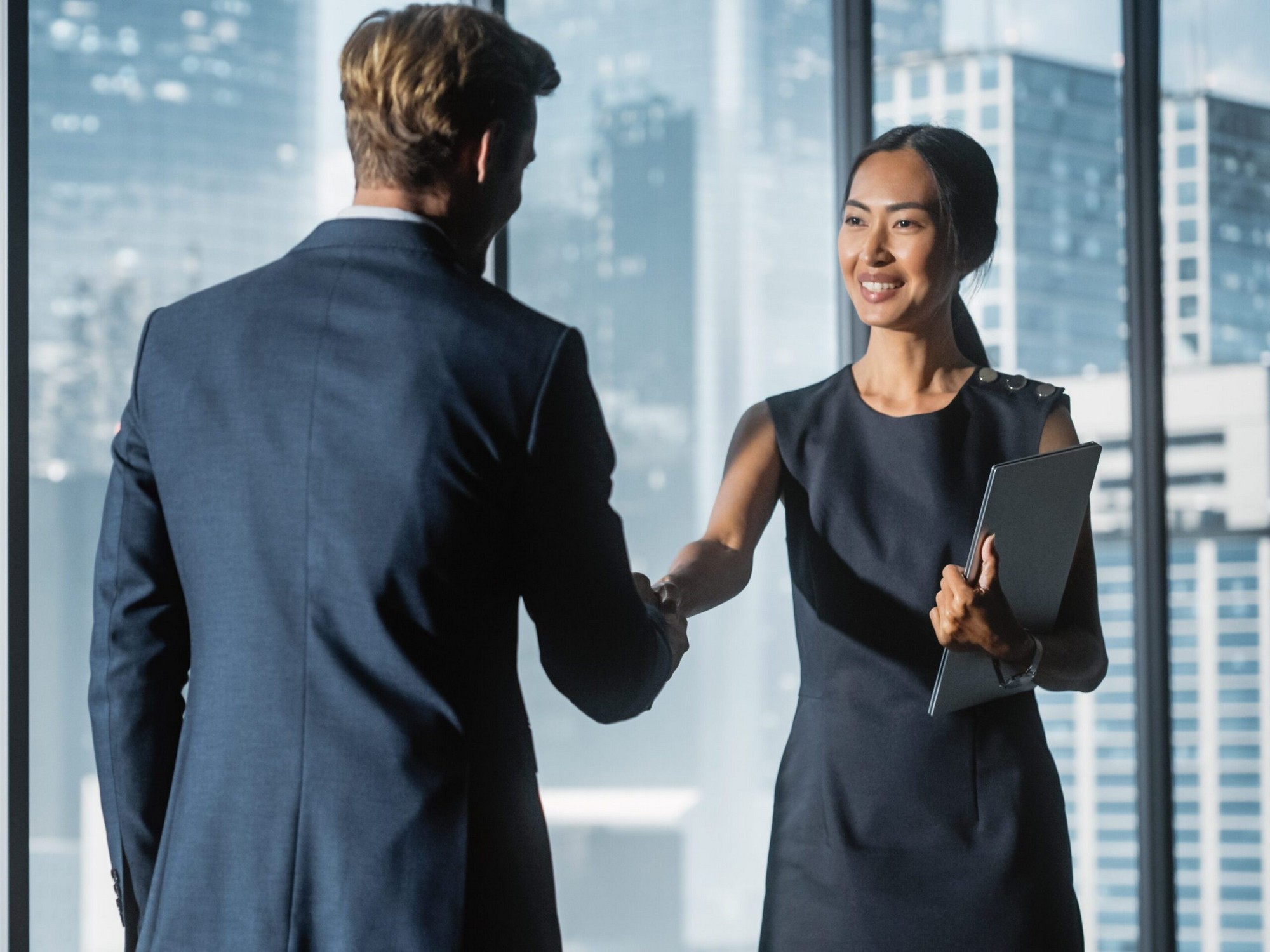 Female,And,Male,Business,Partners,Meet,In,Office,,Shake,Hands. Female,and,male,business,partners,meet,in,office,,shake,hands.